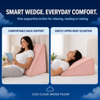 Blush pink wedge pillow supporting a comfortable laptop position in bed